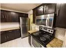 a kitchen with stainless steel appliances granite countertop a stove and a refrigerator