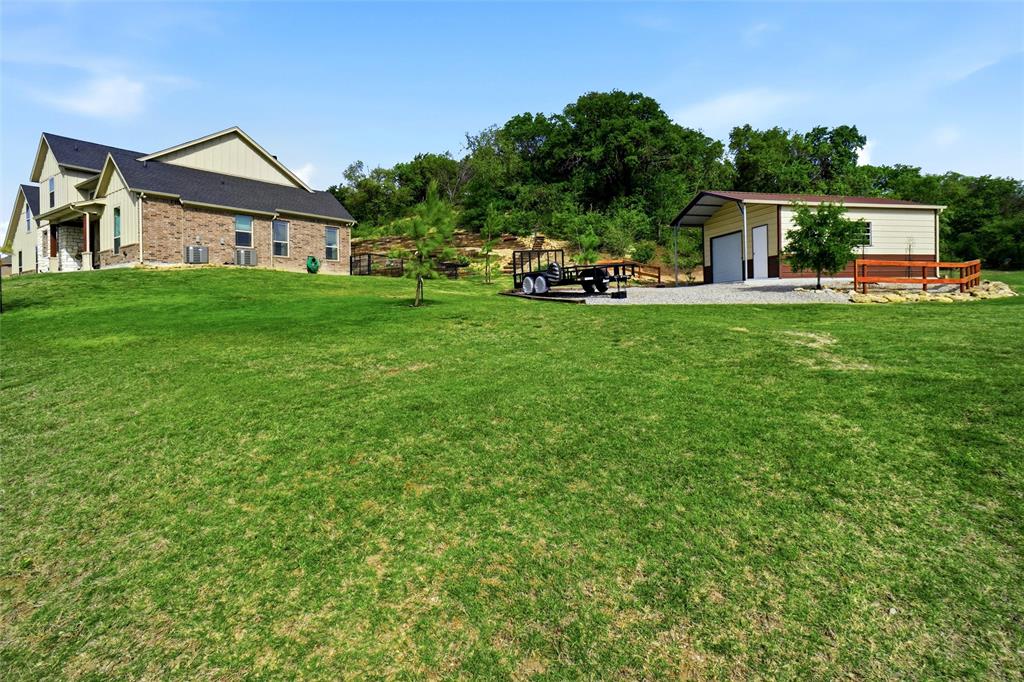 1024 Tex Lane Springtown, TX 76082 - Photo 37 of 40 a front view of a house with garden