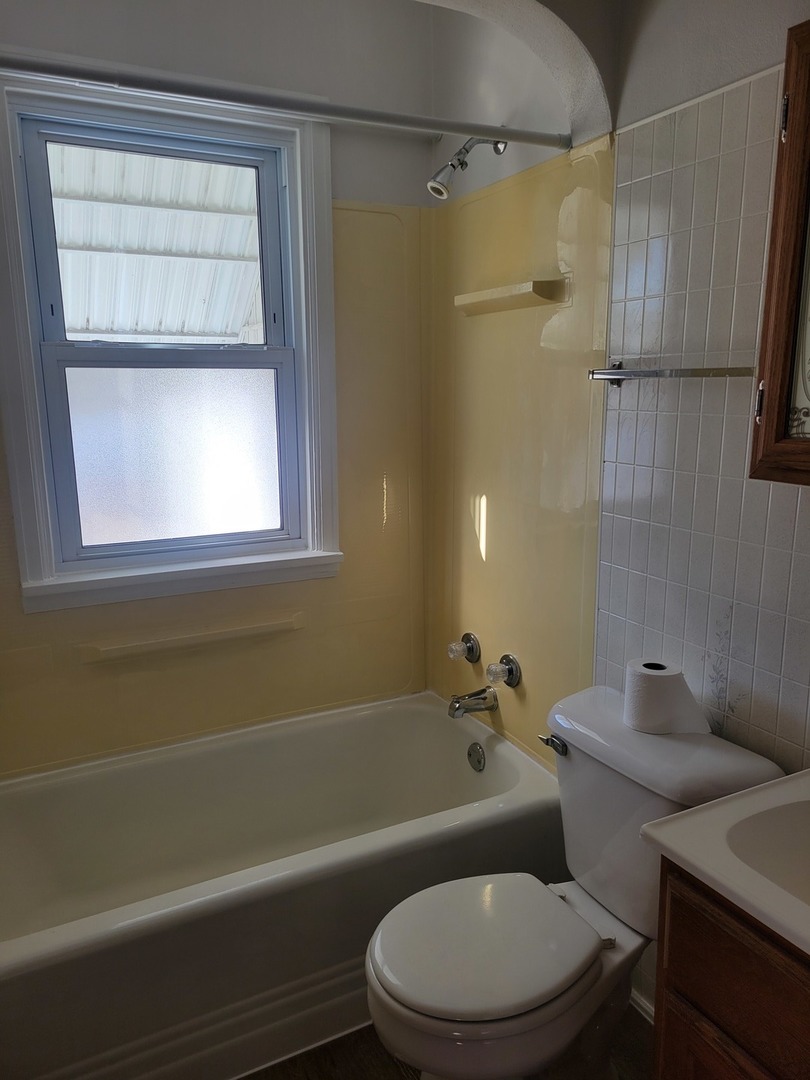 3607 26th Street Moline, IL 61265 - Photo 11 of 12 a bathroom with a toilet and a tub