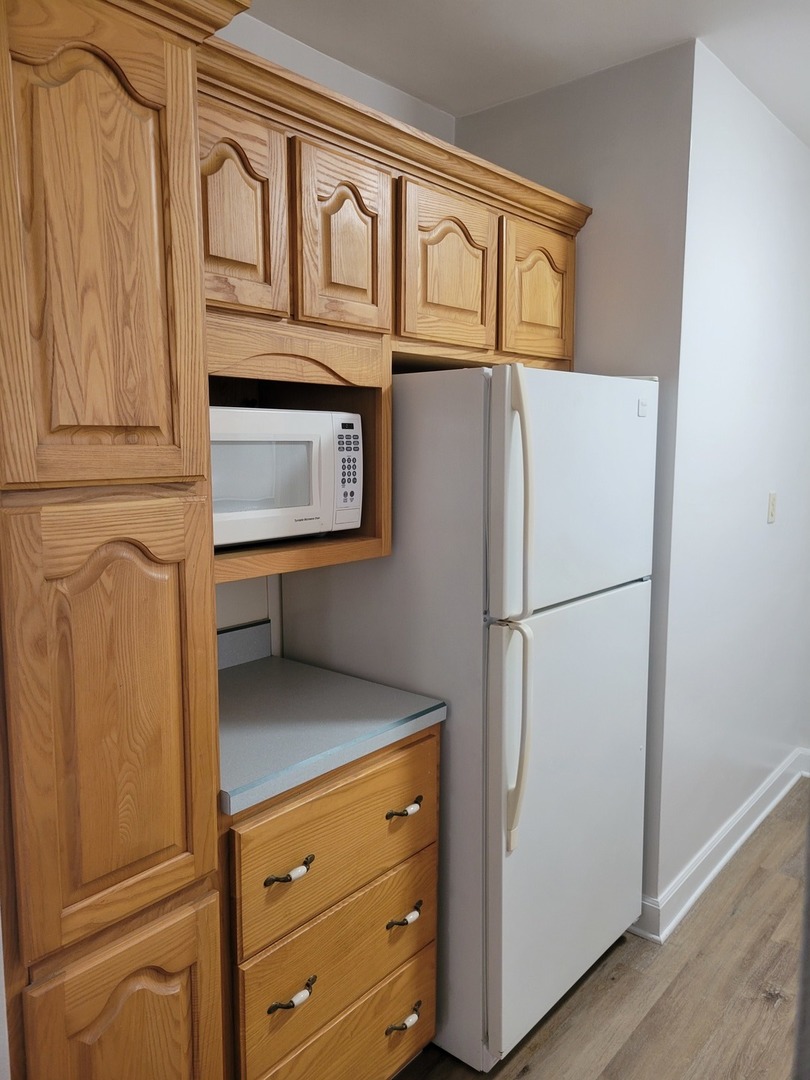 3607 26th Street Moline, IL 61265 - Photo 8 of 12 a white refrigerator freezer and a wooden floor