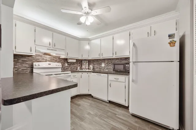 a kitchen with refrigerator a sink and cabinets