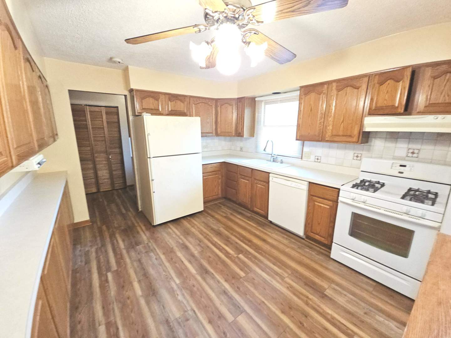75 Bode Road Hoffman Estates, IL 60169 - Photo 2 of 19 a kitchen with a sink a stove a refrigerator and cabinets