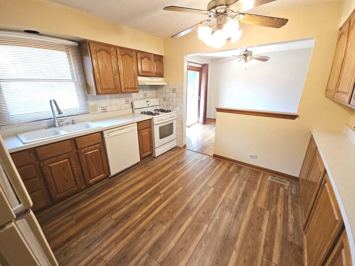 75 Bode Road Hoffman Estates, IL 60169 - Photo 3 of 19 a kitchen with a sink cabinets stainless steel appliances and a window