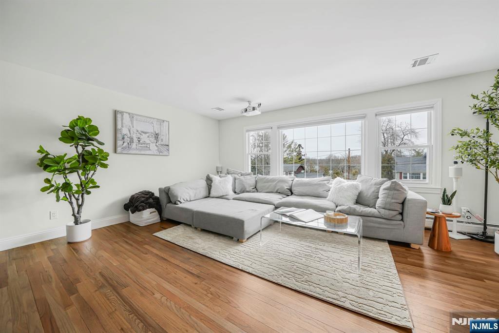 10 Winonah Avenue Wayne, NJ 07470 - Photo 20 of 41 a living room with furniture and a large window with wooden floor