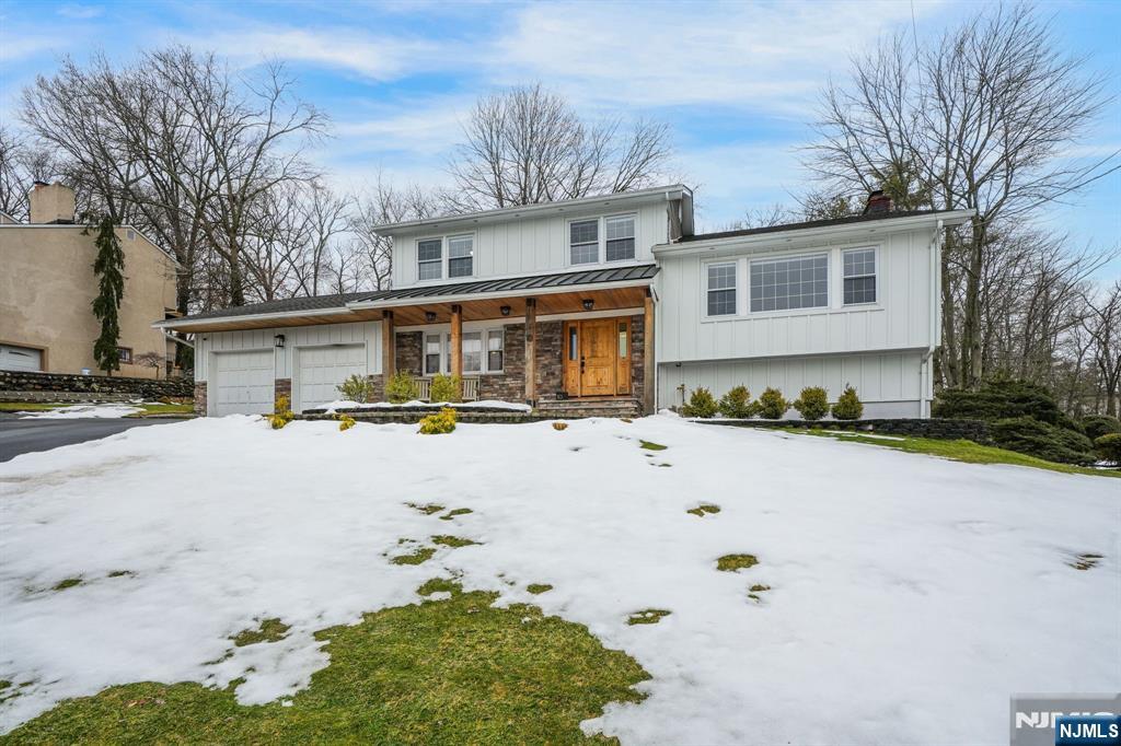 10 Winonah Avenue Wayne, NJ 07470 - Photo 35 of 41 a view of a white house with a yard covered with snow in the center