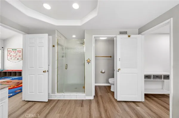 a white toilet sitting next to a bathroom sink and a shower