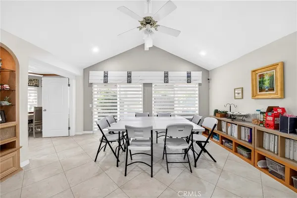 a view of a dining room with furniture and a chandelier