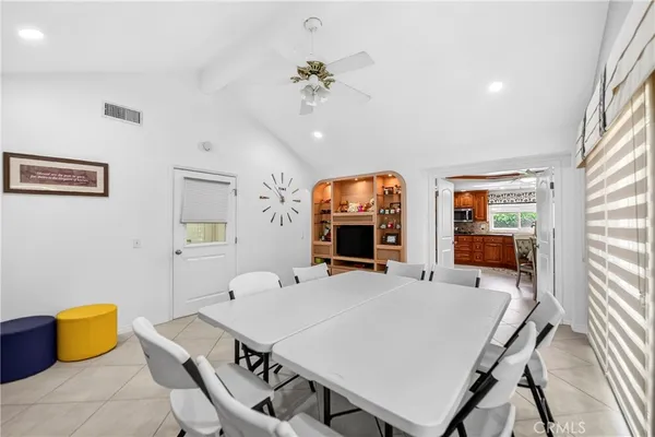 a kitchen with stainless steel appliances kitchen island granite countertop a refrigerator and cabinets