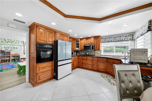 a kitchen with stainless steel appliances granite countertop a sink and microwave