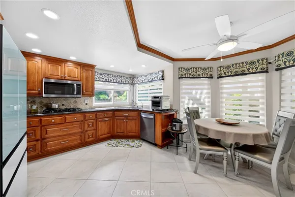 a kitchen with stainless steel appliances kitchen island granite countertop a sink and cabinets