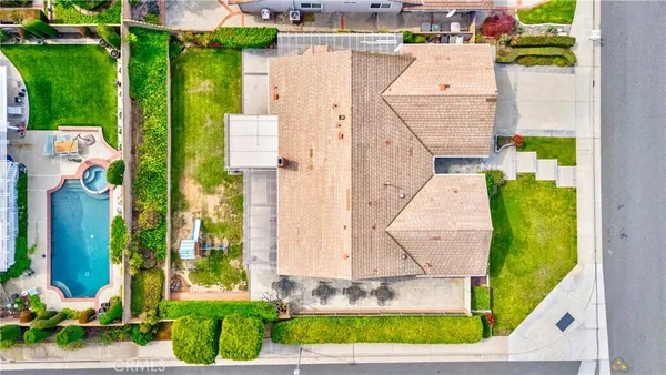 an aerial view of residential house with pool and yard