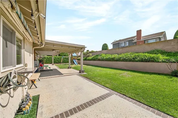 a view of a house with backyard porch and sitting area