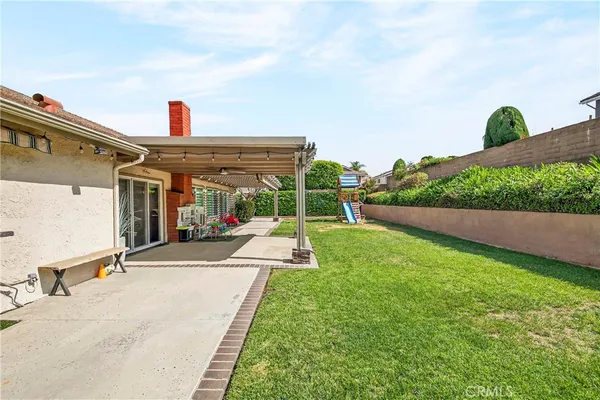 a view of a house with a yard and pathway