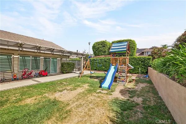 a view of a patio with a table and chairs and floor to ceiling window with wooden fence