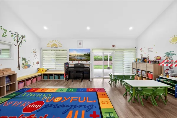 a play room with furniture and a rug