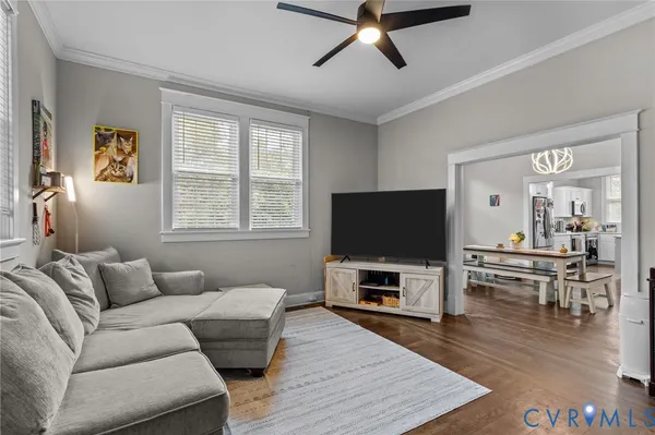 a living room with furniture and a flat screen tv
