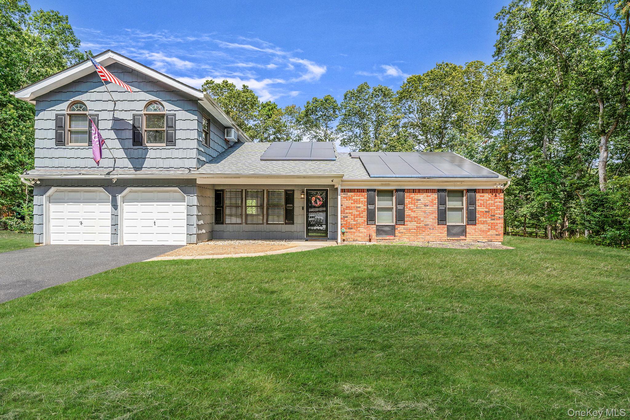 5 Hastings Drive Ridge, NY 11961 - Photo 1 of 31 a front view of a house with a garden