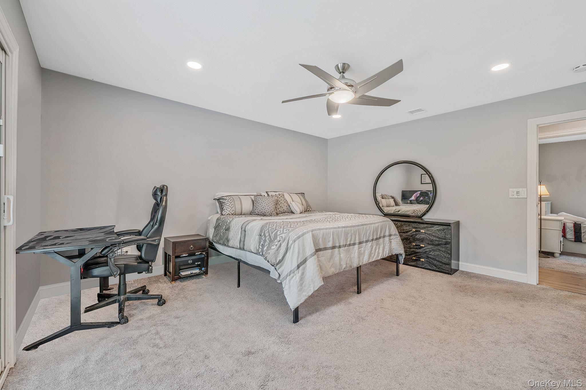 5 Hastings Drive Ridge, NY 11961 - Photo 13 of 31 a bedroom with a bed and a chandelier