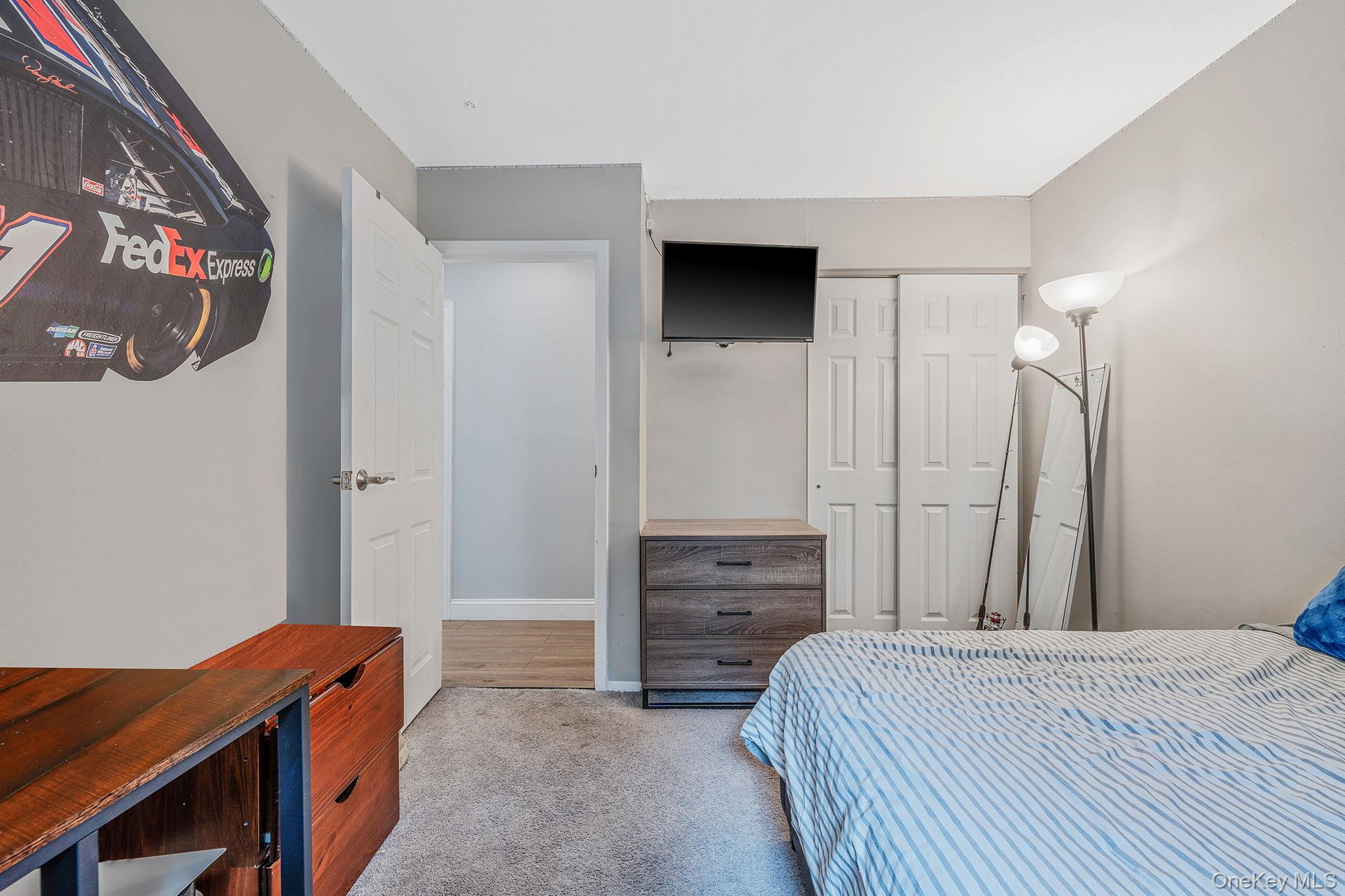 5 Hastings Drive Ridge, NY 11961 - Photo 16 of 31 a bedroom with a bed and a television