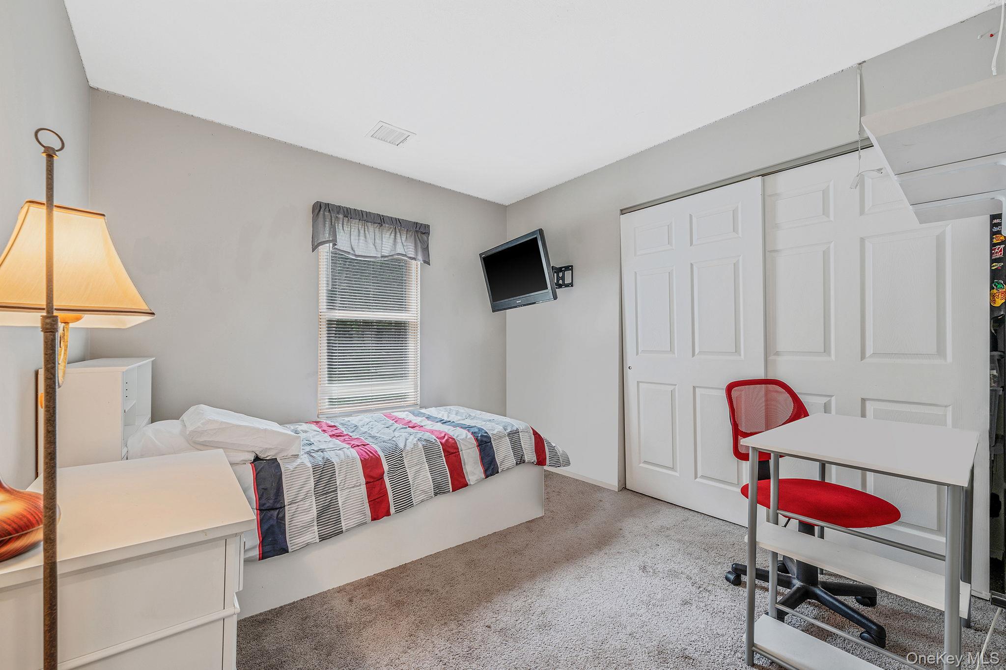 5 Hastings Drive Ridge, NY 11961 - Photo 17 of 31 a bedroom with a bed and furniture