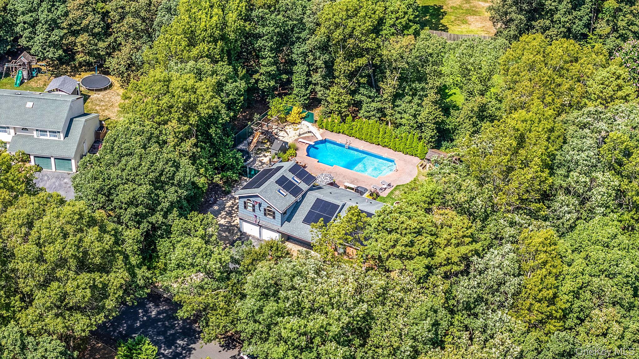 5 Hastings Drive Ridge, NY 11961 - Photo 2 of 31 an aerial view of a house with a yard and outdoor seating