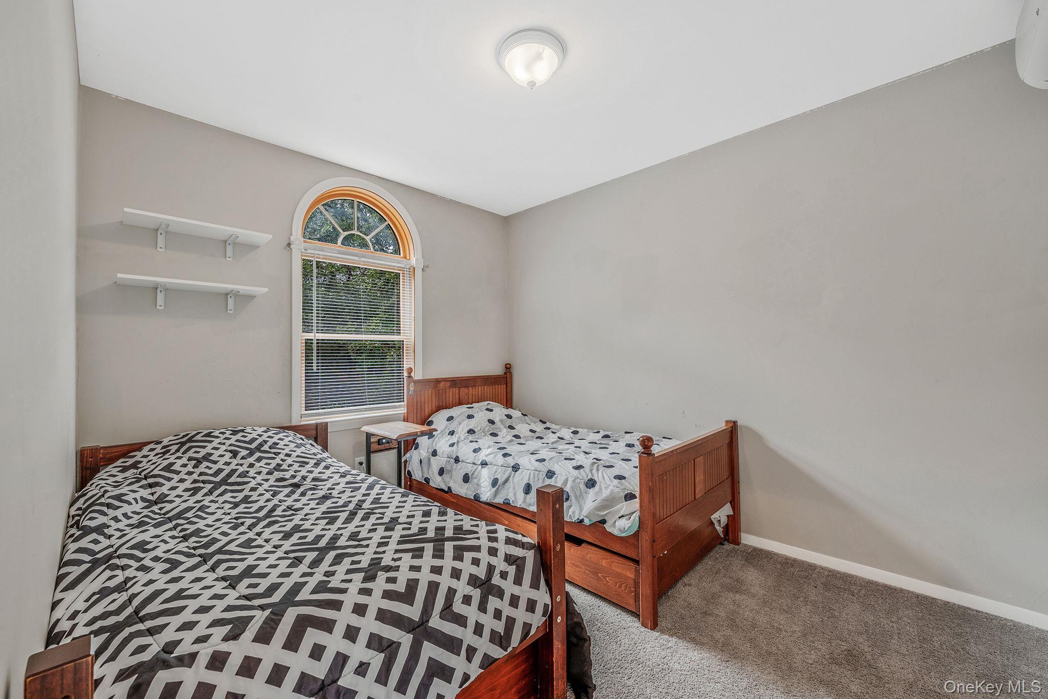 5 Hastings Drive Ridge, NY 11961 - Photo 22 of 31 a bedroom with a bed and a window