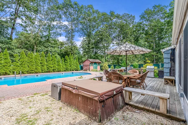 swimming pool view with a seating space