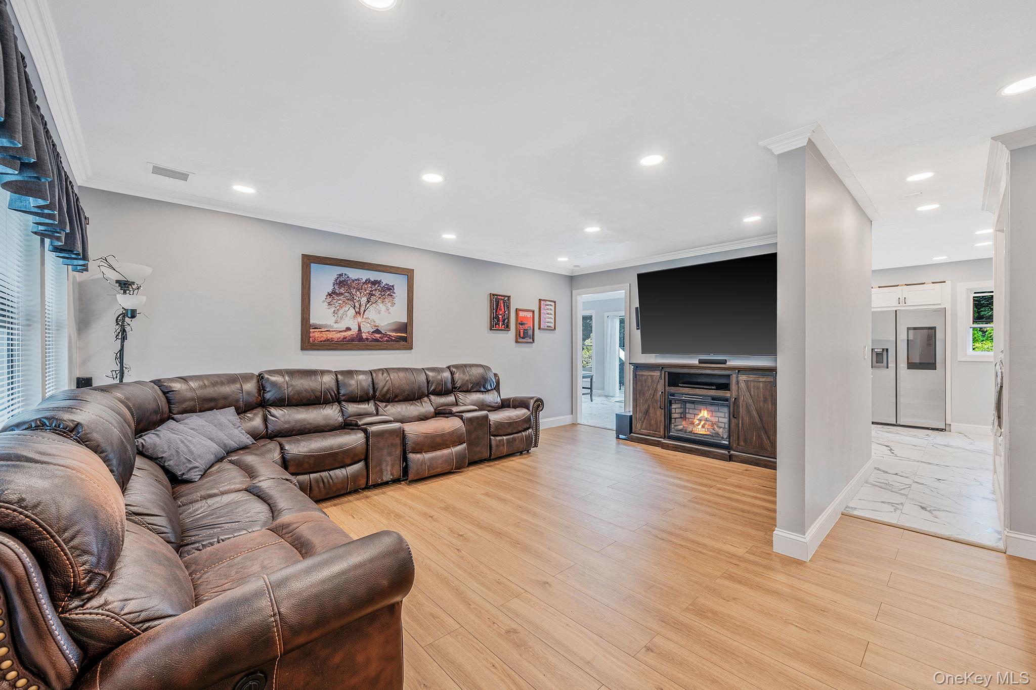 5 Hastings Drive Ridge, NY 11961 - Photo 4 of 31 a living room with furniture and a flat screen tv