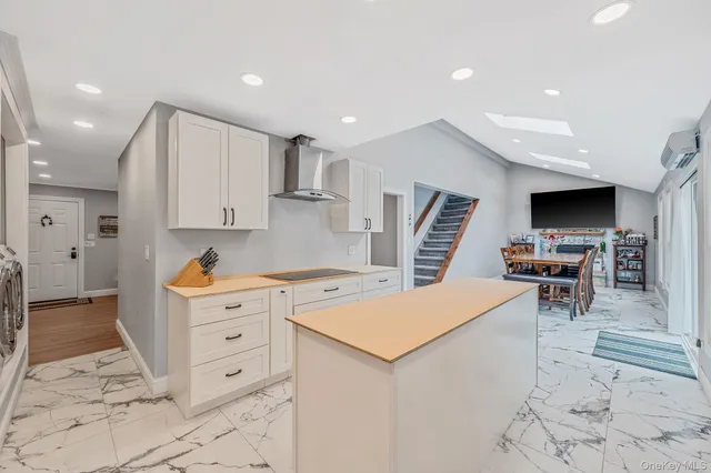 a kitchen with white cabinets and appliances