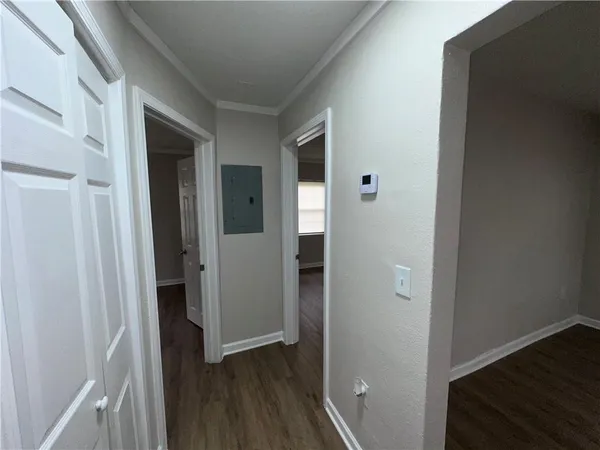 a view of a hallway with wooden floor