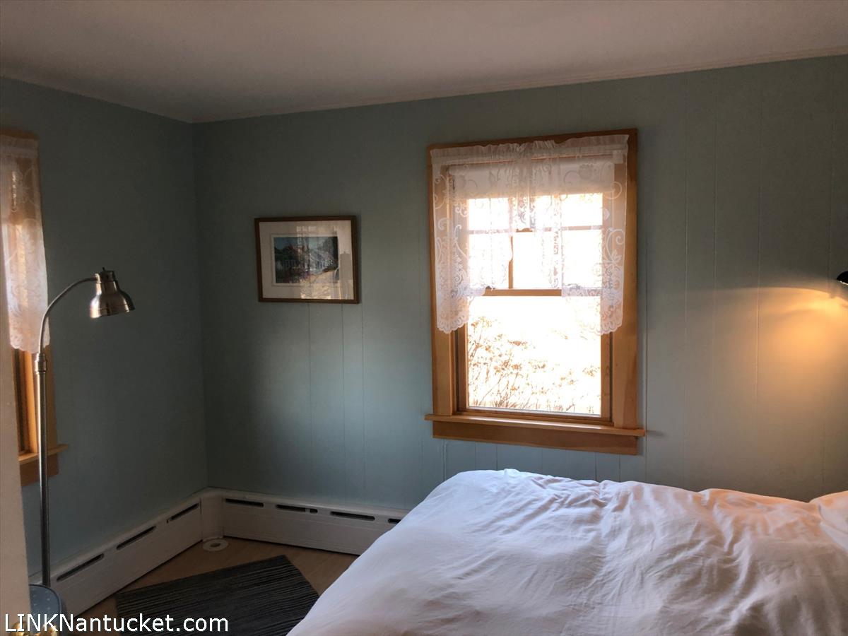 8 M Street Nantucket, MA 02554 - Photo 14 of 20 a bedroom with a bed and a window