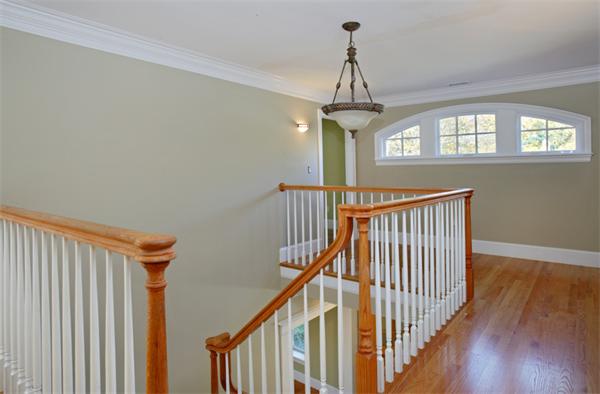 11 Columbine Road Newton, MA 02459 - Photo 10 of 12 a view of a hallway with wooden floor and chandelier