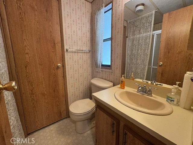 27701 Murrieta Road, Unit 255 Menifee, CA 92586 - Photo 17 of 20 a bathroom with a sink toilet and shower