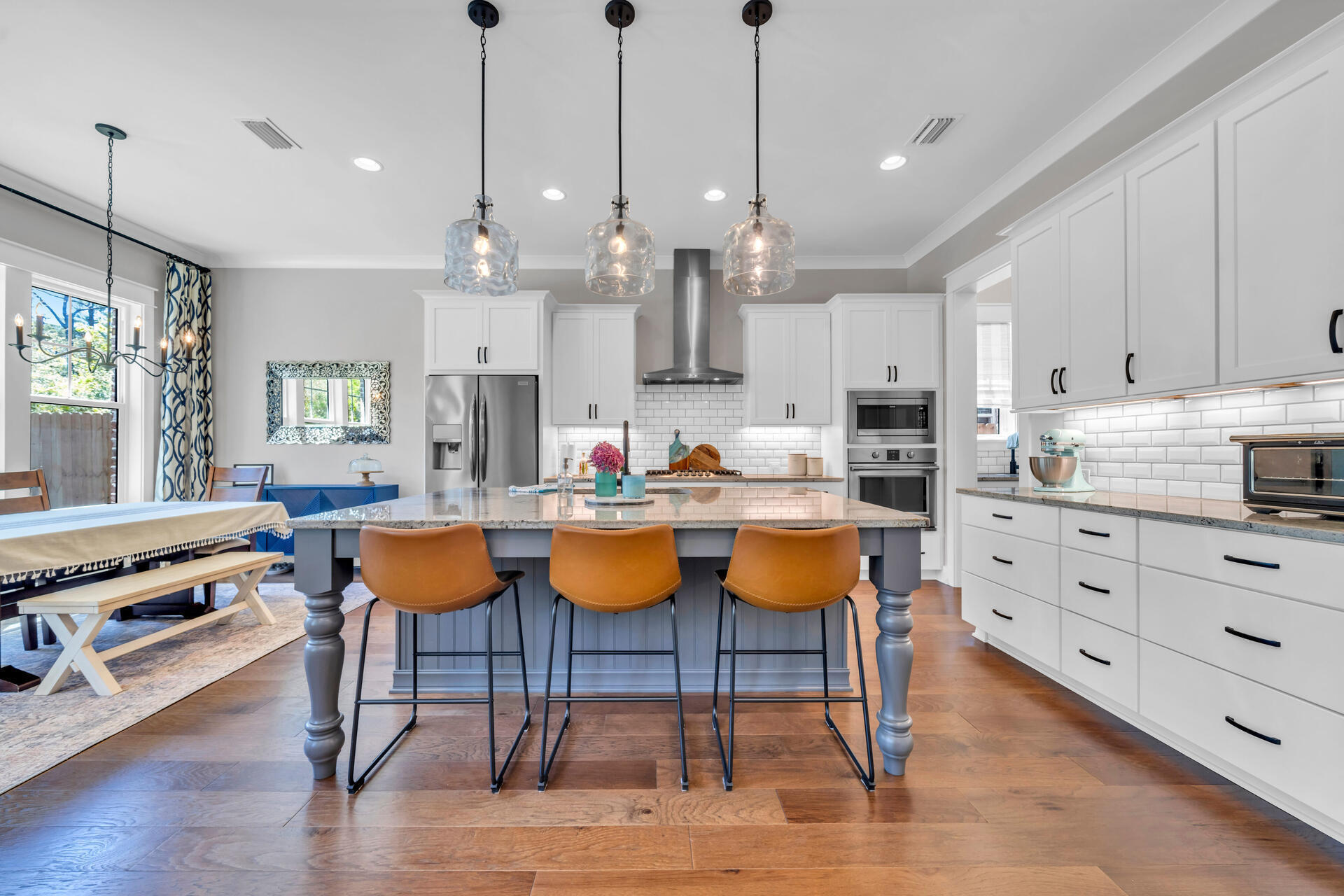 1244 Elderflower Drive Niceville, FL 32578 - Photo 13 of 74 an open kitchen with granite countertop a stove a sink a dining table and chairs with wooden floor