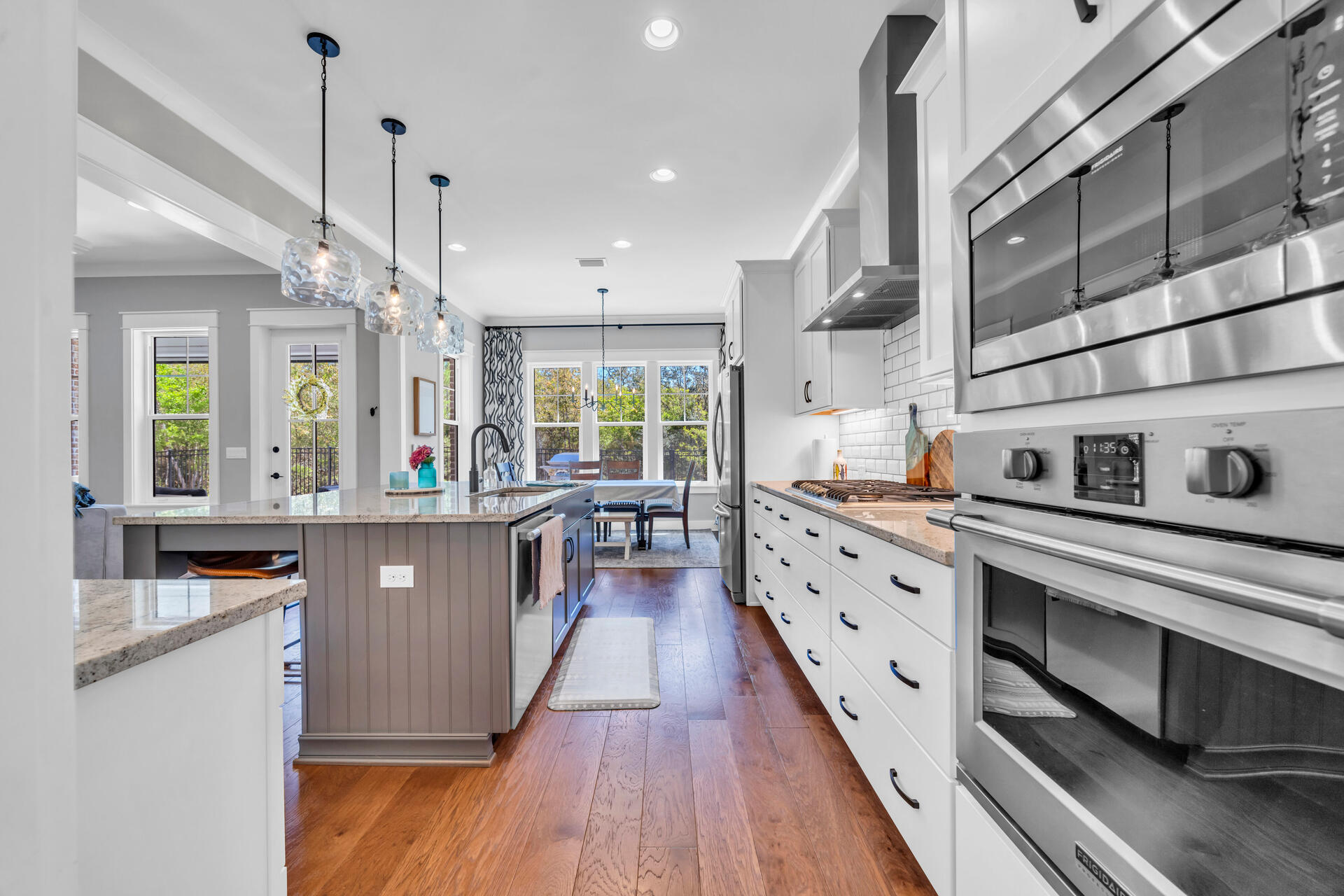 1244 Elderflower Drive Niceville, FL 32578 - Photo 16 of 74 a large kitchen with stainless steel appliances granite countertop a lot of counter space and wooden floors