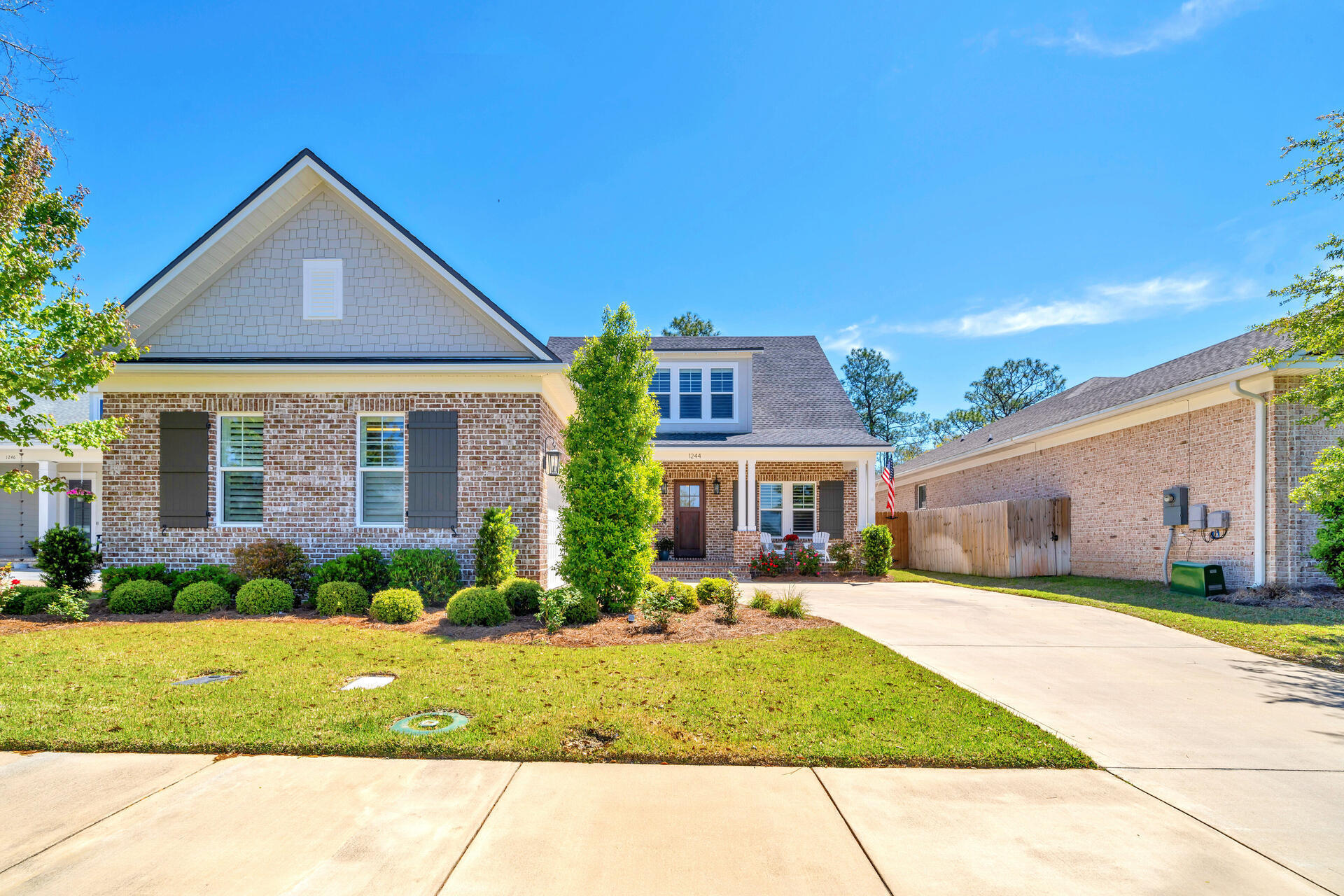 1244 Elderflower Drive Niceville, FL 32578 - Photo 2 of 74 a front view of a house with a yard and garage