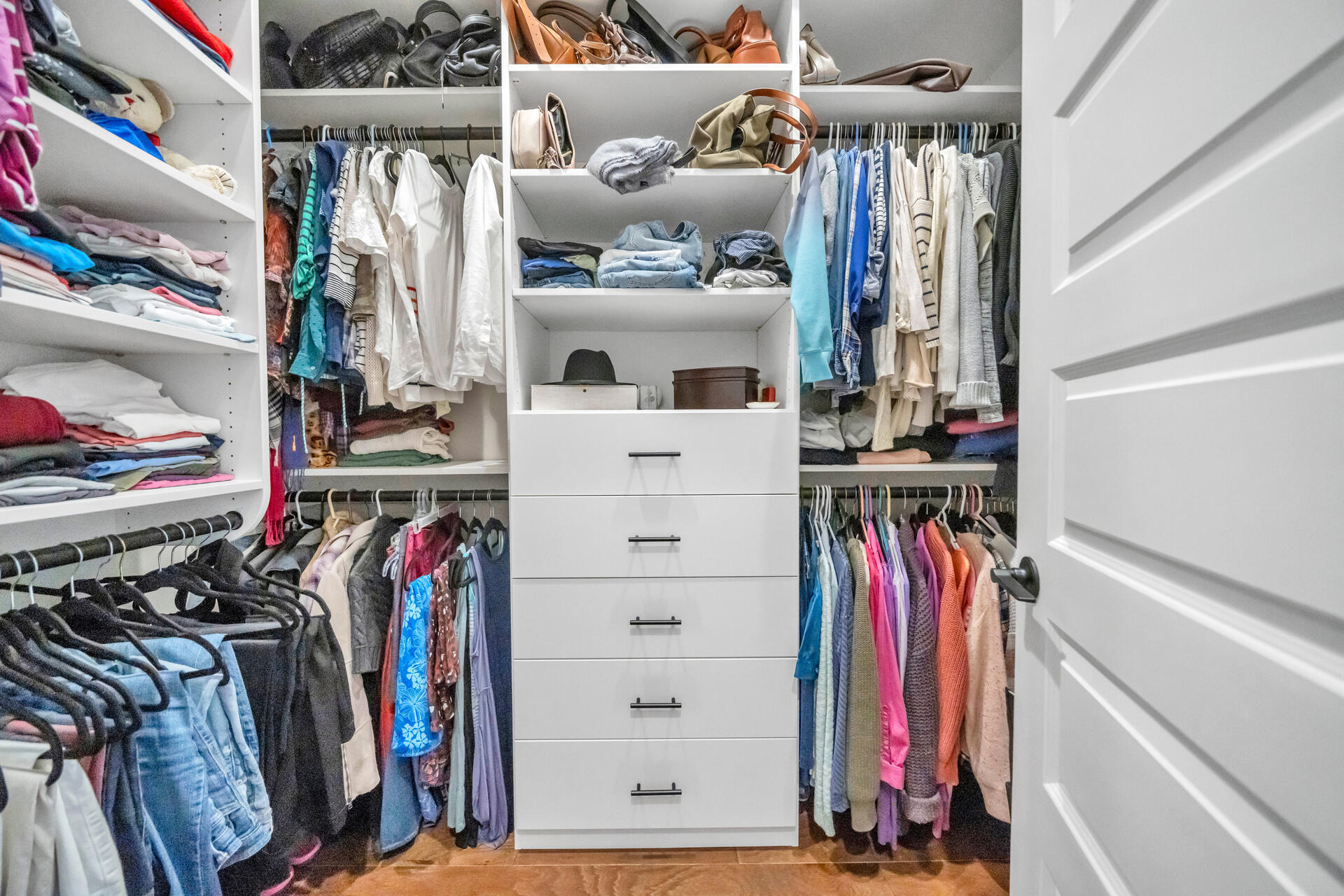 1244 Elderflower Drive Niceville, FL 32578 - Photo 35 of 74 a view of walk in closet with clothes and shoes