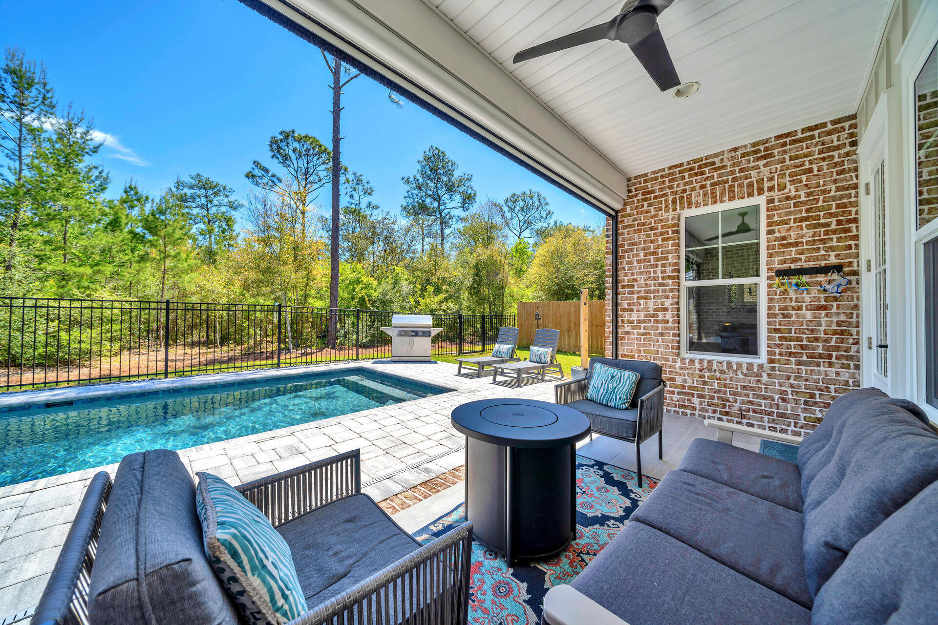 1244 Elderflower Drive Niceville, FL 32578 - Photo 57 of 74 a view of a patio with couches table and chairs and potted plants