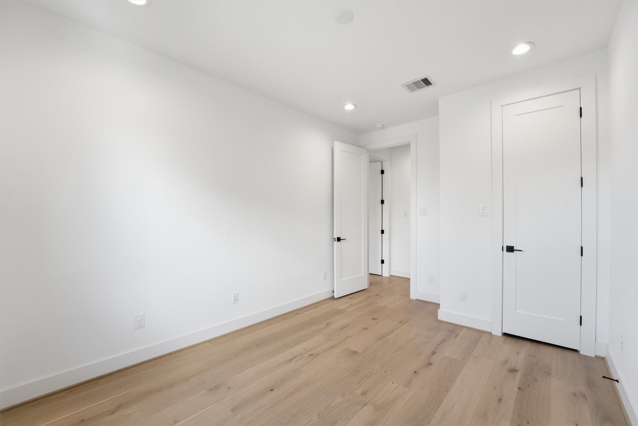 5004 Darling Street Houston, TX 77007 - Photo 26 of 41 Spacious third bedroom with natural light and sleek wood flooring. Ideal for guests