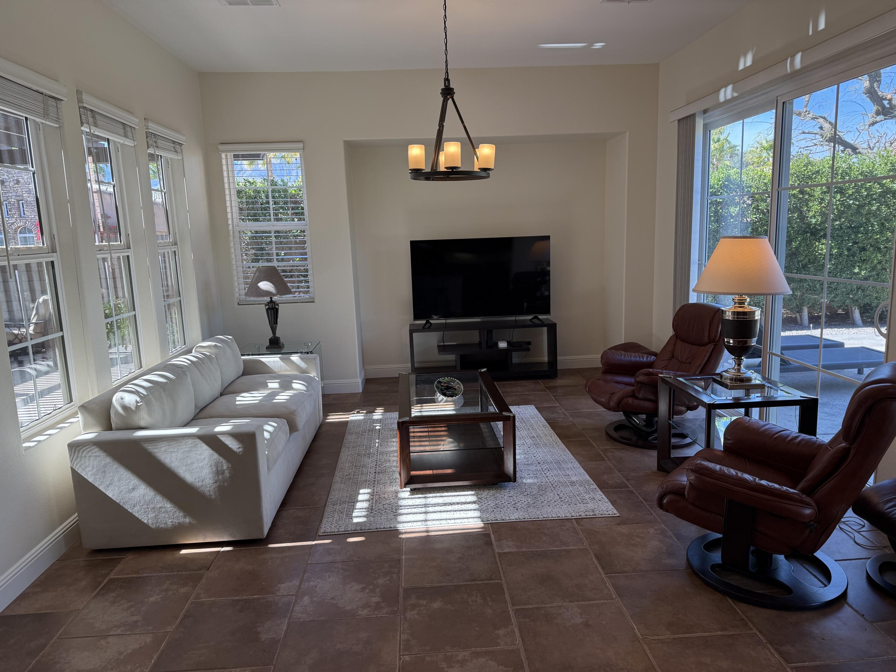 2 Via Santa Elena Rancho Mirage, CA 92270 - Photo 15 of 51 a living room with furniture a flat screen tv and a large window