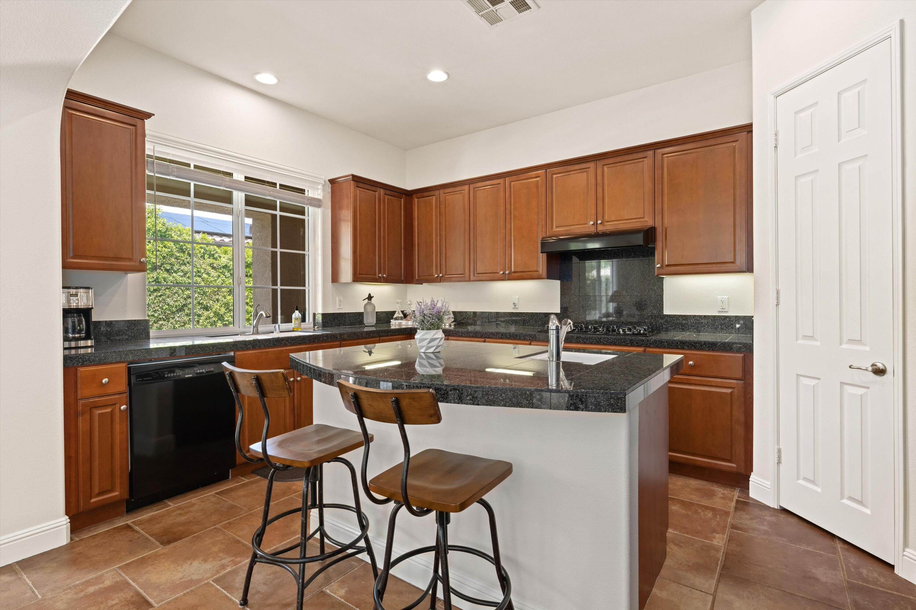 2 Via Santa Elena Rancho Mirage, CA 92270 - Photo 16 of 51 a kitchen with stainless steel appliances granite countertop a stove a sink dishwasher and a refrigerator