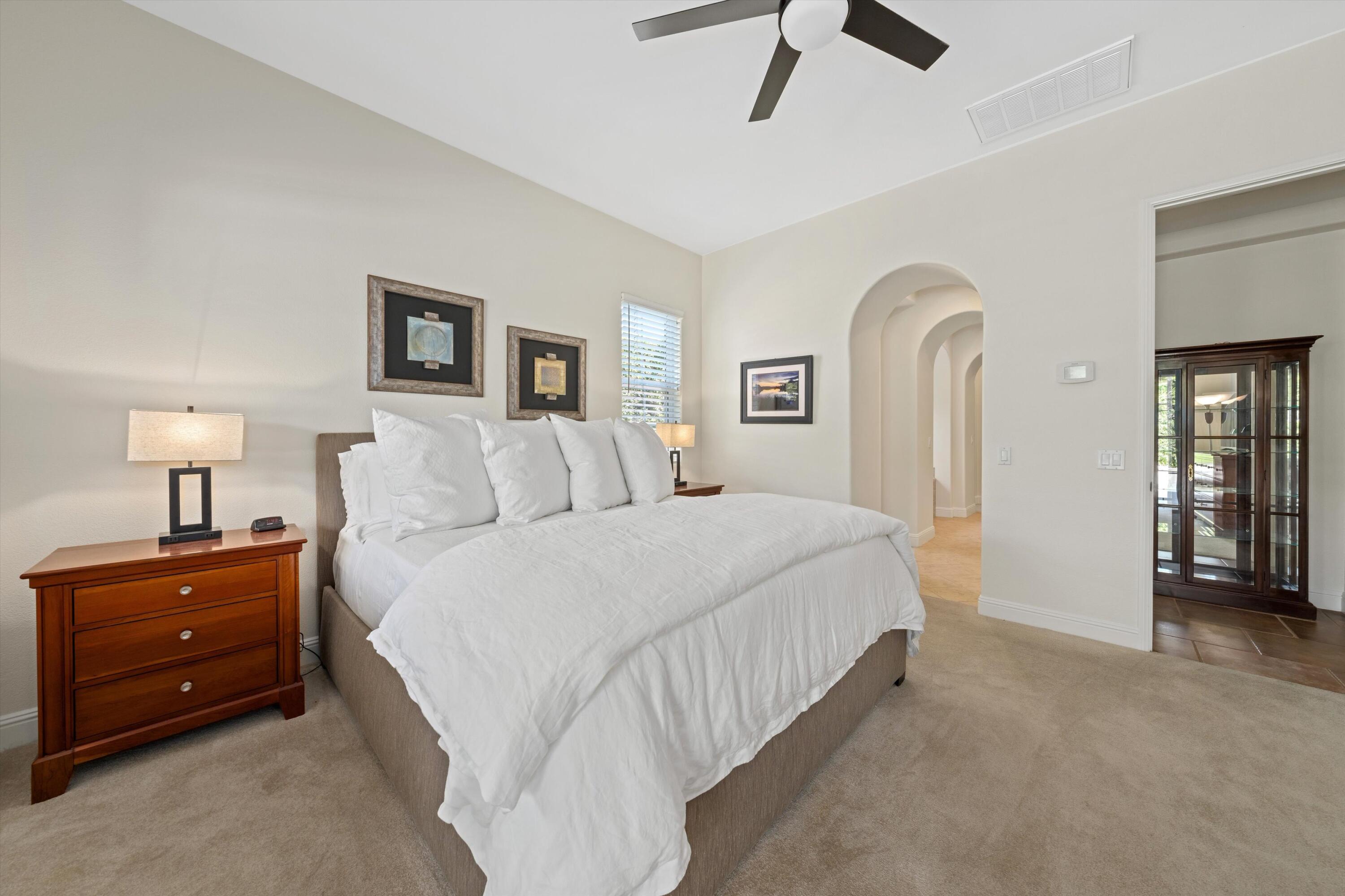 2 Via Santa Elena Rancho Mirage, CA 92270 - Photo 21 of 51 a spacious bedroom with a bed and a chandelier