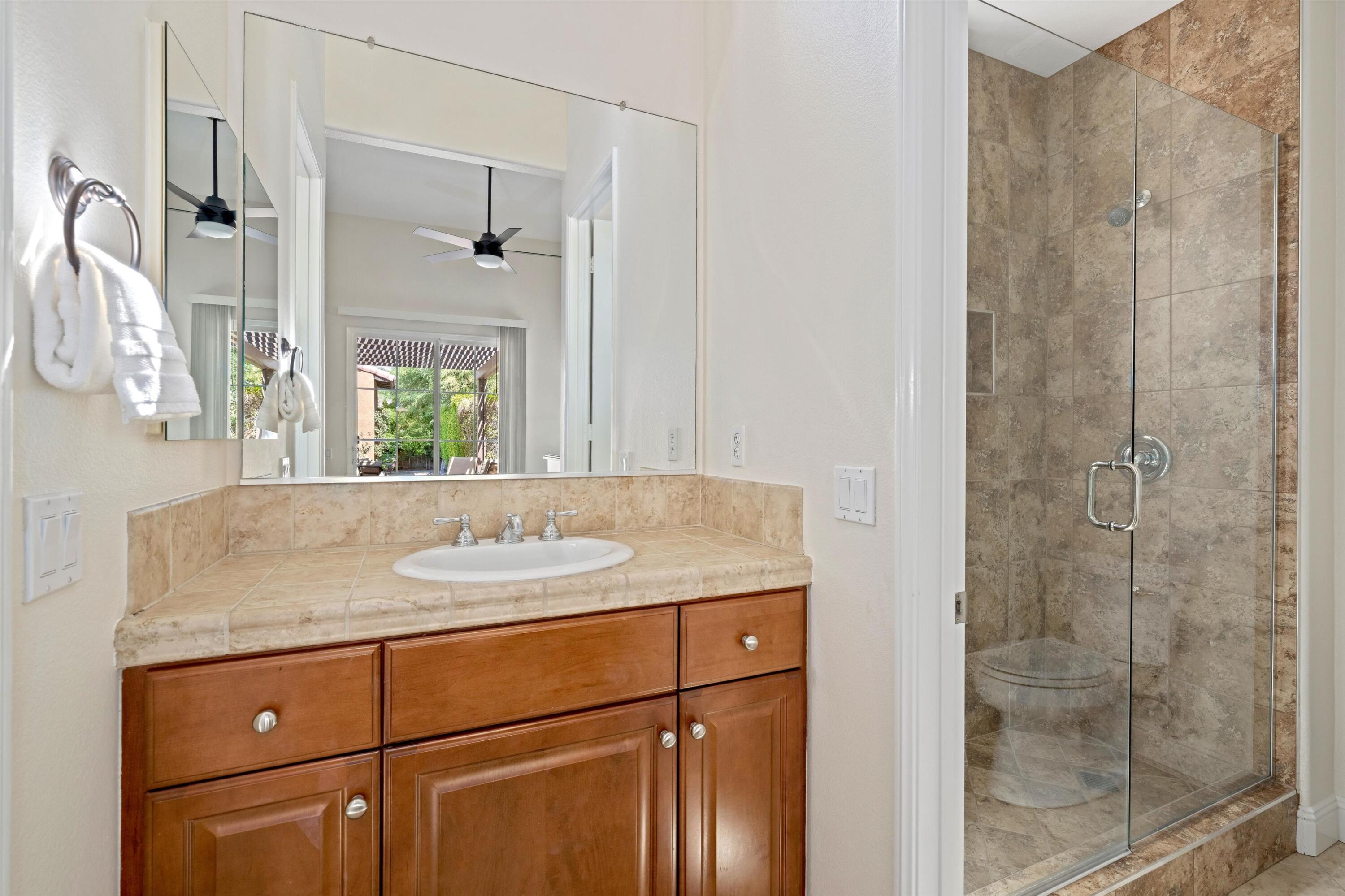 2 Via Santa Elena Rancho Mirage, CA 92270 - Photo 27 of 51 a bathroom with a granite countertop sink a mirror and shower