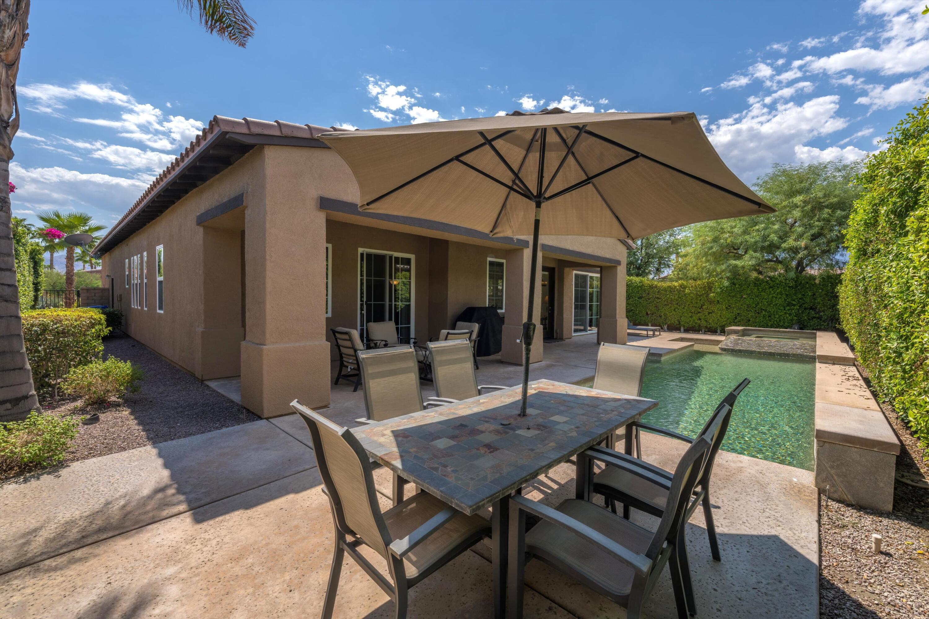 2 Via Santa Elena Rancho Mirage, CA 92270 - Photo 6 of 51 a patio with a table and chairs under an umbrella