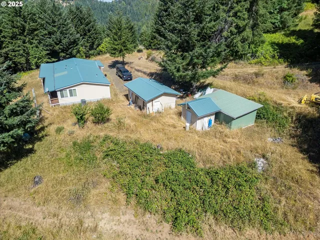 a view of a house with a bed and a yard