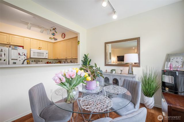 a dining room with furniture and wooden floor