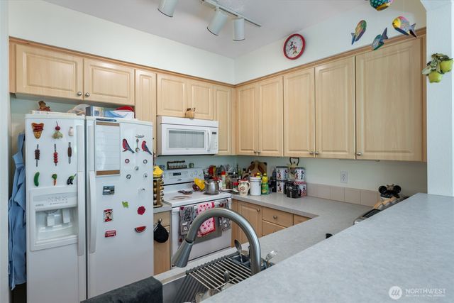 a kitchen with stainless steel appliances a refrigerator sink and cabinets