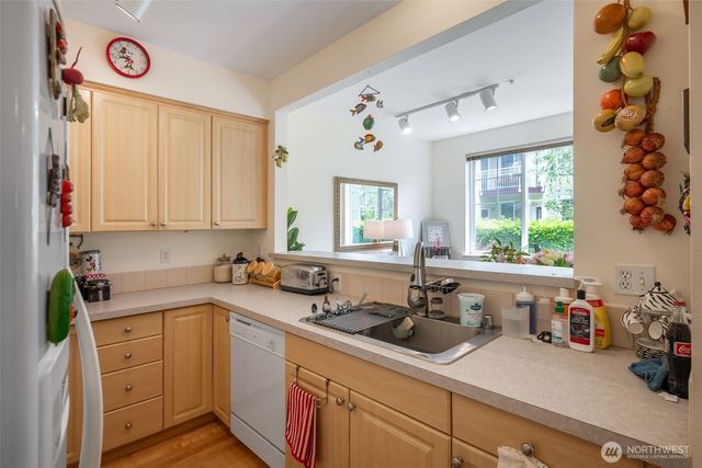 a kitchen with a sink cabinets and window