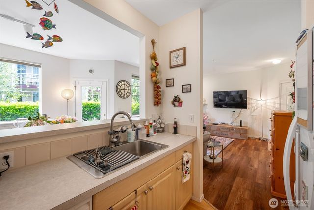 a kitchen with stainless steel appliances a sink a stove and a refrigerator