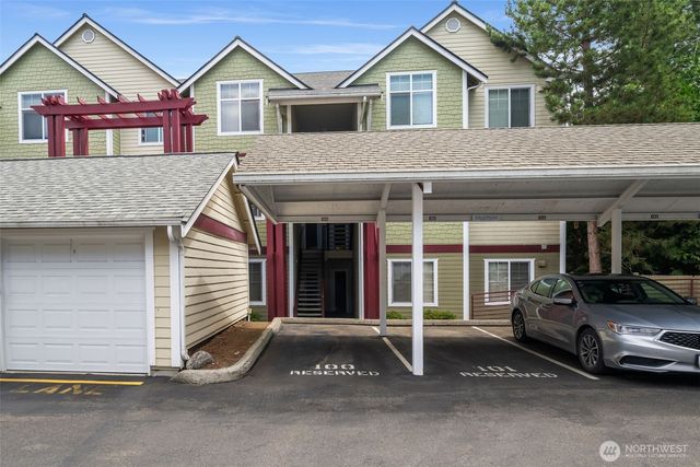 a view of a house with a patio and a yard
